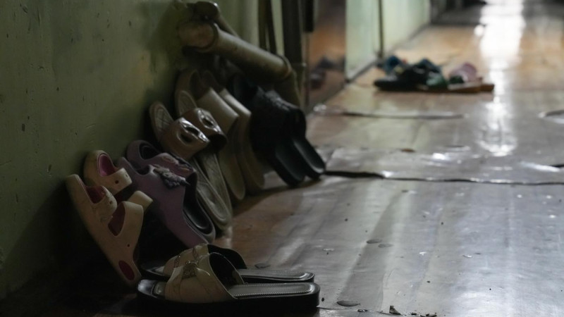 Обувь многодетной семьи у двери в комнату в одном из общежитий Астаны. Фото: ©️ Tengrinews.kz / Маржан Куандыкова